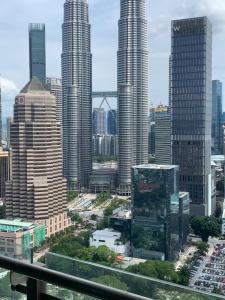 a view of a city skyline with tall buildings at Legasi Kampung baru guest house by rumahrehat 1908sqft huge balcony for BBQ twin tower view in Kuala Lumpur