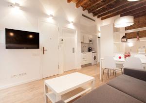 a living room with a couch and a table at Habitat Apartments Alissia in Barcelona