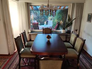 a dining room with a wooden table and chairs at Spacious for 5 - kitchen - House - Wifi in Nordhorn