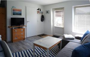 a living room with a couch and a table at Apartment Nordstübchen in Klixbüll