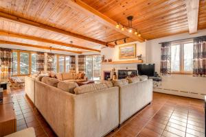 a living room with a large couch and a tv at Cascade Village Area 5 bed 4 bath, Walk to lift! in Vail