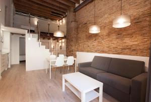 a living room with a couch and a table at Habitat Apartments Alissia in Barcelona