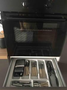 an open oven with some utensils in it at Alloggio incantevole/ bedsitting-room in Altavilla Milicia