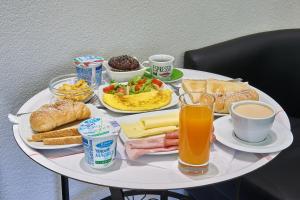 a white table with breakfast foods and drinks on it at Room 230 Roma Luxury Suites in Rome