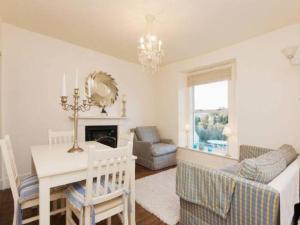 a living room with a table and a dining room at Harbour View in Kingswear