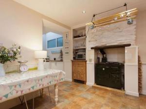 a kitchen with a table and a stove at Harbour View in Kingswear