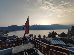 a view of a body of water with a flag at Hotel Kajiinn in Pokhara
