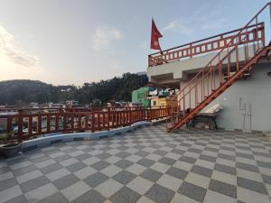 a balcony with a staircase on the side of a building at Hotel Kajiinn in Pokhara