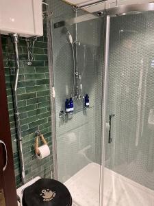 a bathroom with a glass shower and a toilet at Ocean Mist Leith in Edinburgh