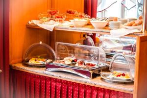 a buffet line with plates of food on display at Hotel Corvinus Vienna - Newly Renovated in Vienna