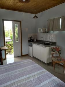 賓海洛的住宿－Vila Sabará，一间卧室配有一张床,厨房配有水槽