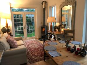 a living room with a couch and a table at May House A beautiful Cornish holiday home in the heart of Cornwall in Wadebridge