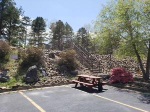 a picnic table sitting in a parking lot in a park at Hot Springs Village Inn in Hot Springs Village