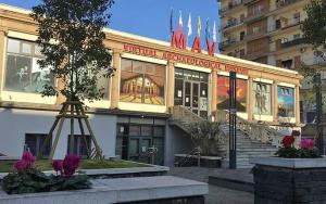a building with a sign on the side of it at Federico's House in Ercolano
