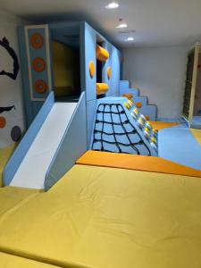 a childrens play room with a slide in a room at Next to Yas Island's Gems - canal+pool view in Abu Dhabi
