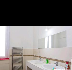 a bathroom with two sinks and a large mirror at Central Hostel Milano in Milan