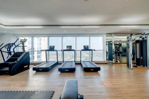 a gym with treadmills and cardio equipment in a building at Luxury Apt - Rooftop Pool - City View in Dubai
