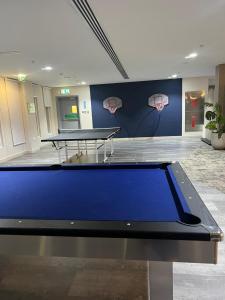 a ping pong table in a room with a basketball wall at Next to Yas Island's Gems - canal+pool view in Abu Dhabi