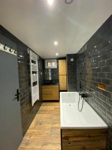 a bathroom with a white sink and a brick wall at Lautaret 5 G0 in Les Deux Alpes