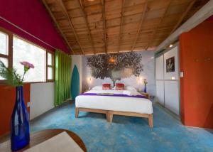 a bedroom with a large bed in the middle of it at Hotel Pochote Mazunte in Mazunte