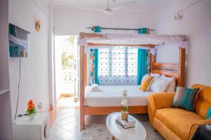 a living room with a bed and a couch at Urban studios in Kilifi