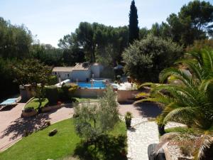 a view of a garden with a swimming pool at Mas les vieux chênes in Lambesc