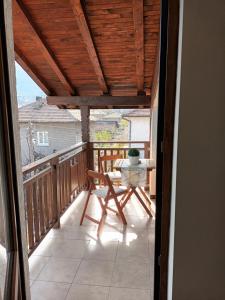 a view of a porch with a table on a balcony at Guest rooms Bansko in Bansko