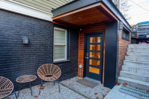 a house with two chairs and a door and stairs at A Foodies Delight and Cumberland Charm in Portland