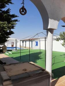 a view of a tennis court with a cage at Casa Rural Horizontes de la Mancha in El Toboso