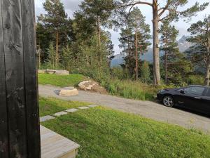 a car parked on the side of a road at Minihuset ved skogen in Isfjorden +1 photo