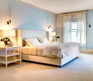 a bedroom with a bed and two lamps and a window at Gateways Inn in Lenox