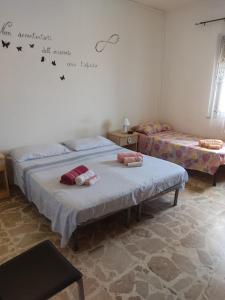 a bedroom with two beds and a writing on the wall at Il Girasole in Crotone
