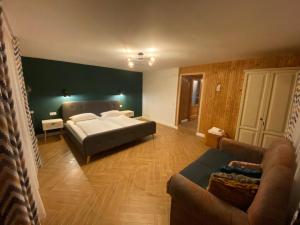 a large bedroom with a bed and a couch at Cabana Kodru in Vatra Dornei