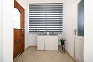a hallway with a window with a blind at Holiday House IRENA 1 in Posedarje +93 photos