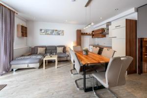 a kitchen and living room with a table and a couch at Apartment-Alpenfantasie in Zell am See