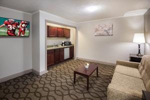 a living room with a couch and a table at Red Roof Inn & Suites Lexington - Hamburg in Lexington