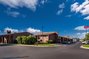 a parking lot in front of a building at Red Roof Inn & Suites Lexington - Hamburg in Lexington