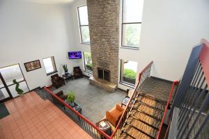 a living room with a staircase and a fireplace at Red Roof Inn & Suites Lexington - Hamburg in Lexington