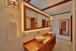 a bathroom with two sinks and a large mirror at Pousada Xalés de Maracaípe in Porto De Galinhas +107 photos