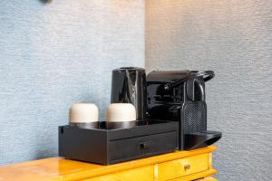 a coffee maker sitting on top of a table at Canal Suites in Bruges