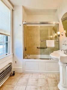 a bathroom with a tub and a sink at Gateways Inn in Lenox