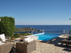 a villa with a swimming pool and a view of the ocean at Orfos Villas in Agios Nikolaos