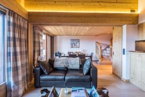 a living room with a couch and a table at Wonderful appartement in a chalet with balcony - Megève - Welkeys in Megève