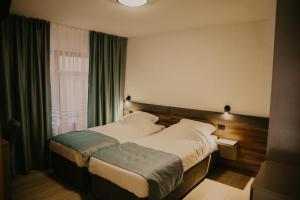 a hotel room with a bed and a window at Saray&App in Sarajevo