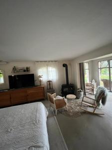 a bedroom with a bed and a living room with a fireplace at Le clos sainte Marie in Roquefort-les-Pins