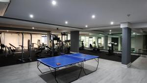 a gym with a ping pong table and exercise equipment at Urban Park Apartment in Durban