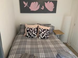 a bed with pillows on it in a bedroom at 42 NELSON ST in Largs