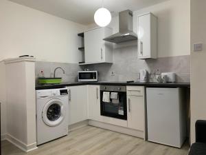a kitchen with a washing machine and a washer at 42 NELSON ST in Largs