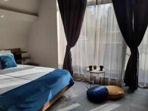 a bedroom with a bed and a large window at Вила Bora Vista 1 in Tsigov Chark