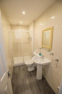 a bathroom with a sink and a toilet and a shower at Granite City Guest House in Aberdeen